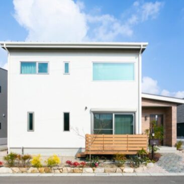 白い外壁が印象的な、シンプルで都会的な二階建て住宅の外観